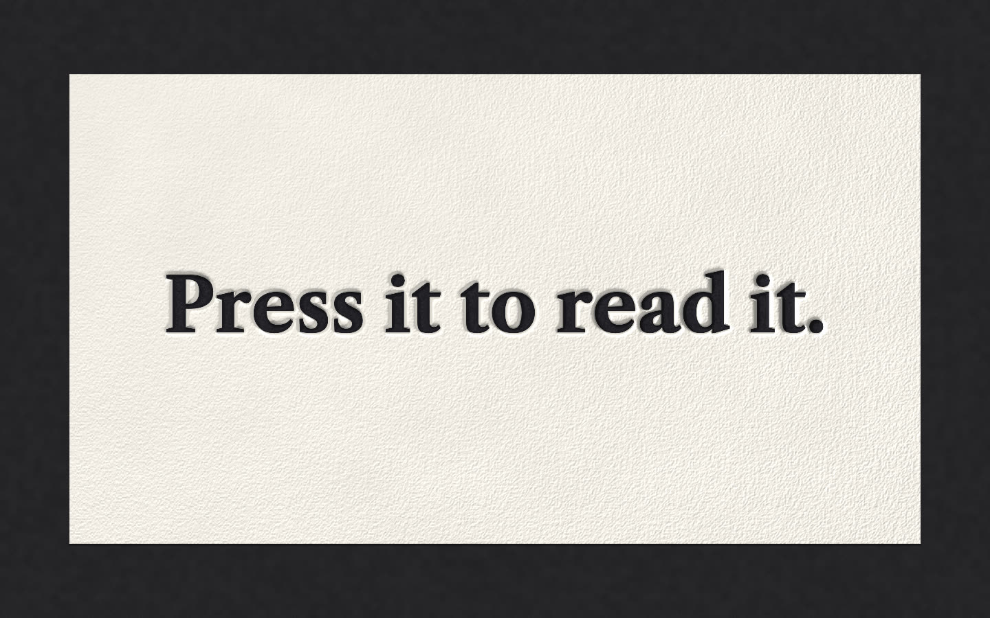 The printed sheet, “Press it to read it.” (still image)